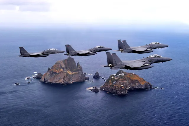 Four F-15K fighters in formation above Dokdo in the East Sea