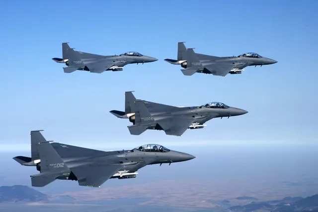 Four F-15Ks in formation high above a coastline