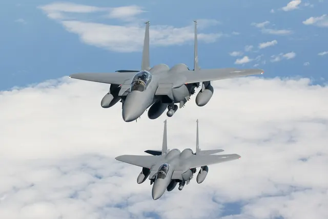 Two F-15Ks flying towards the camera above a solid cloud layer