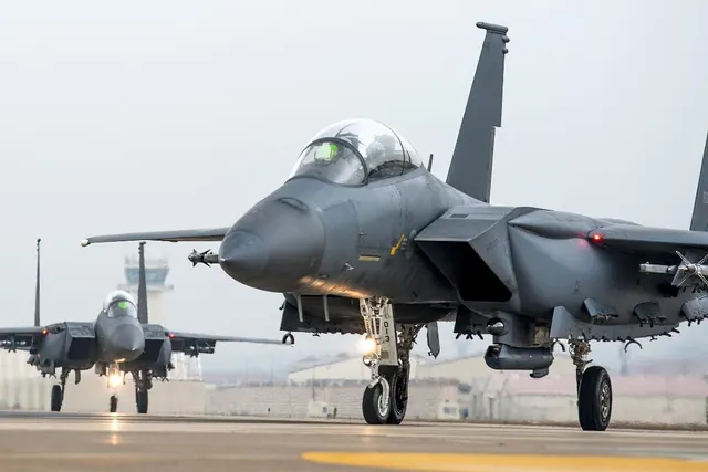 Two F-15Ks taxiing towards the camera in haze with landing gear down